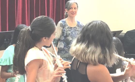 Melissa leads flute students in rehearsal