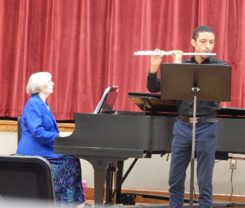 college student performs in recital with piano accompanist