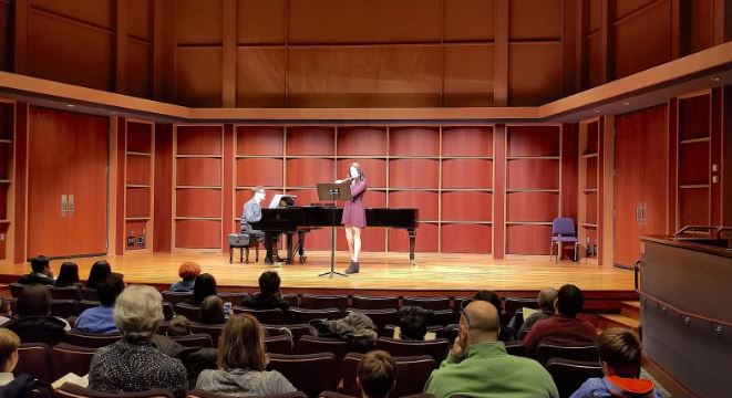 student performs in recital with piano accompanist