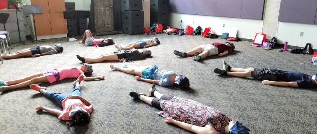 students relax in yoga for musicians class