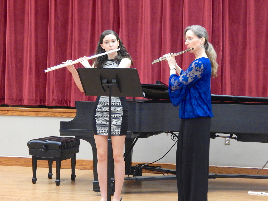 Melissa plays in recital with high school student