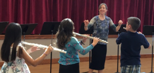 Melissa directs students in flute camp rehearsal